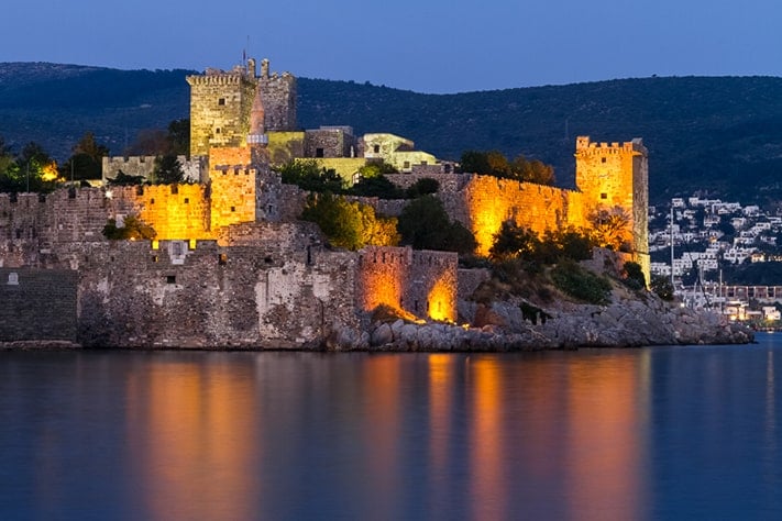 địa-điểm-du-lịch-thổ-nhĩ-kỳ-Das Bodrum Kalesi oder St. Peter Kastell in abendlicher Beleuchtung ist das Wahrzeichen und eine der Hauptsehenswürdigkeiten der türkischen Küstenstadt Bodrum